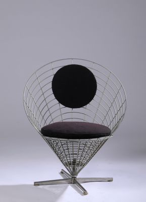 the chair is made of metal and has a black cushion on it