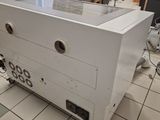 a white refrigerator sitting on a tiled floor in a room