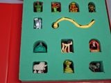 a green box with a bunch of toy figures in it