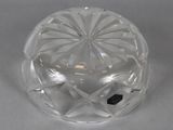 a clear glass bowl with a black dot on it