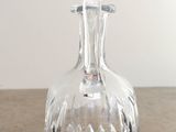 a clear glass bottle sitting on top of a table