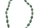 a close up of a necklace with green beads on a white background