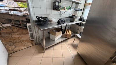 a stainless steel refrigerator in a kitchen with a lot of counter space
