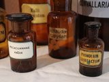 several bottles of medicine are lined up on a table