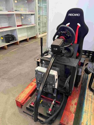 a video game machine sitting on a pallet in a warehouse