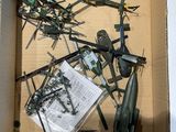a cardboard box filled with assorted military items