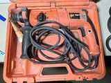 an orange tool box with a cord and a drill in it