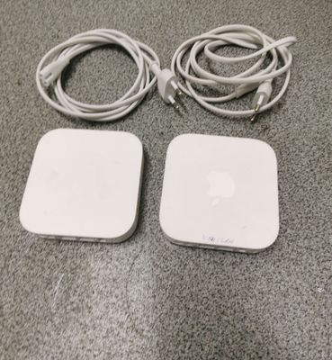 an image of two white apple products sitting on a table