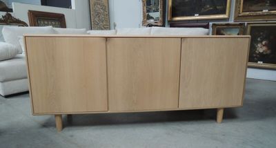 a picture of a cabinet in a room with pictures on the wall