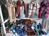 many scarves and scarves on display on a table