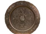 a metal plate with a floral design on it