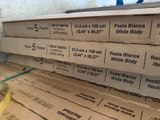 a stack of pizza boxes sitting on top of a table