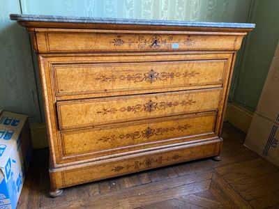 a wooden dresser with a marble top in a room