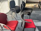 four chairs in a room with a table and a window