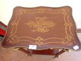 a small table with a brown and gold design on it