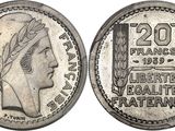 a silver coin with a woman ' s head on it