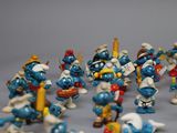 many figurines of smurfs that are posed together