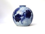 a blue and white vase sitting on a white surface