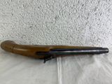 an old rifle with a wooden handle on a plastic sheet
