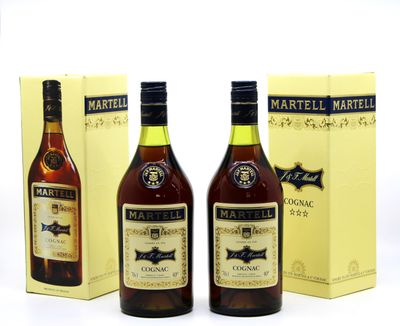 three bottles of martelli brandy and a box of wine on a table
