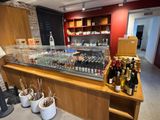 a counter that has a lot of bottles of wine on it