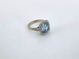 an image of a ring with a blue topaz stone and diamonds