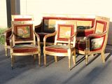 three chairs and a couch in the middle of the street