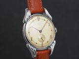 a close up of a wrist watch with a brown leather strap