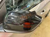 a close up of a car ' s side view mirror with a ruler on it
