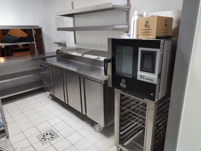 a kitchen with stainless steel cabinets and a microwave