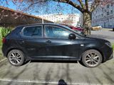 a black car parked on the side of the street