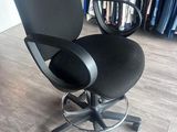a black office chair that is sitting in a room