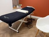 an image of a massage room with a chair and a table