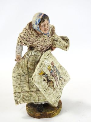 figurine représentant une femme tenant un panier et un livre
