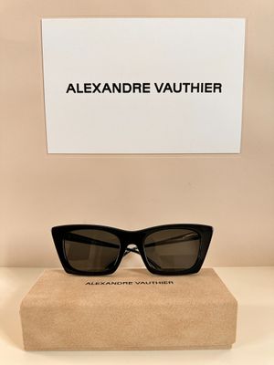 a pair of black sunglasses sitting on top of a cardboard box
