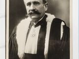 an old photo of a man in a robe with a moustache on his face