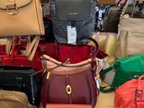 a lot of purses on a table in a store