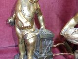 pair of antique bronze figurines of a boy and a bird