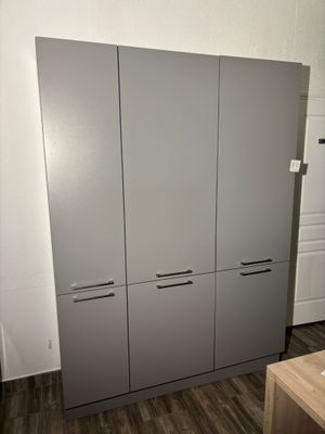 cabinets in a room with wood flooring and white walls