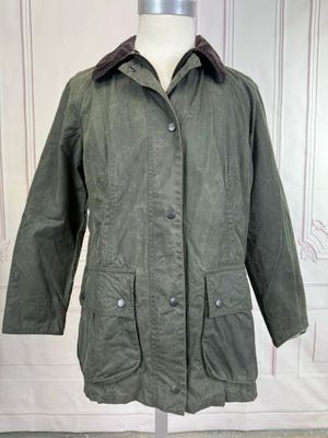 the jacket is green and has a brown collar on it