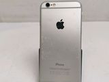 a silver iphone sitting on top of a white table