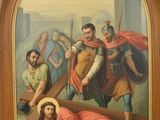 painting of jesus carrying the cross with other people in the background