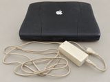 a laptop and a charger sitting on a table
