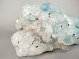 a cluster of blue and white crystals sitting on a table