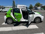 a small white car with a green and white design on it