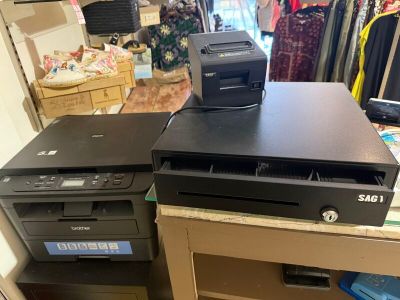 two computers and a printer sitting on top of a desk