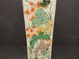 an image of a vase with a bird and flowers painted on it
