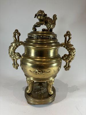 a large brass urn with two lions on it