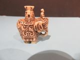 a figurine of an elephant with a man on top of it