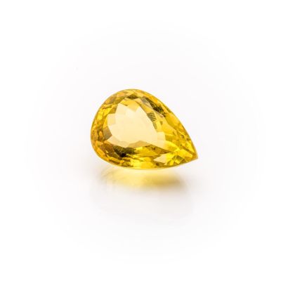 a yellow sapphire stone on a white background